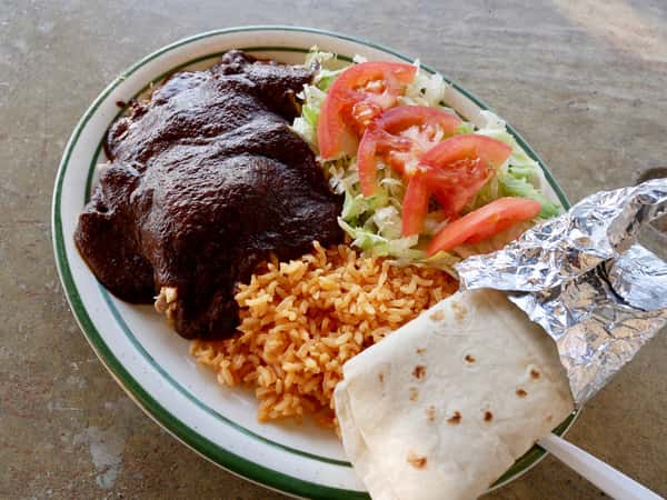 burrito platter with rice, salad, and mole