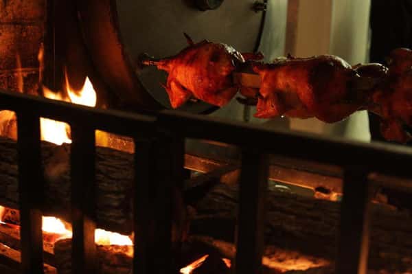 chickens on rotisserie over fire