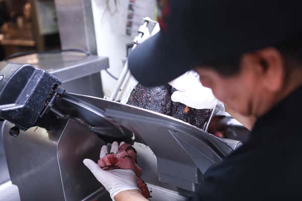 staff shot slicing pastrami