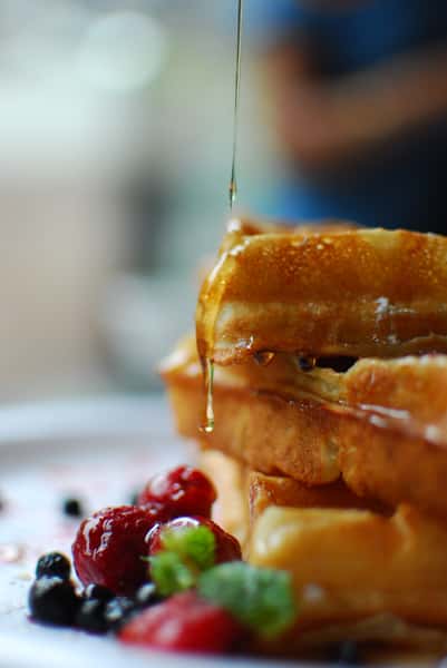 Syrup drizzling over waffles