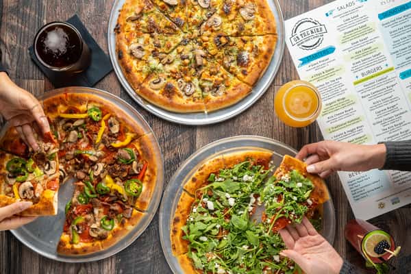 Guests eating a variety of pizza
