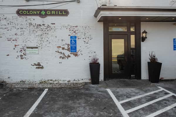 Colony Grill exterior white painted brick wall