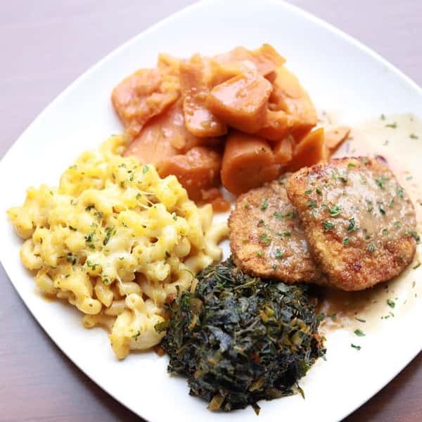 Vegan Chicken with home made mac'n cheese, brown sugar candy yams, with spicy perfectly cooked greens. Grandma's Sunday dinner with a twist!