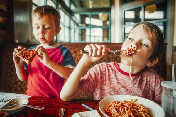 Kids eating pasta
