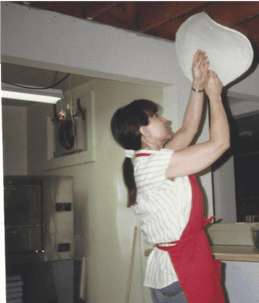 Gloria Smith tossing dough