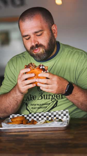 man enjoying burger