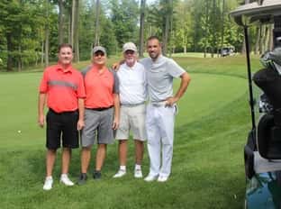 four people on golf course