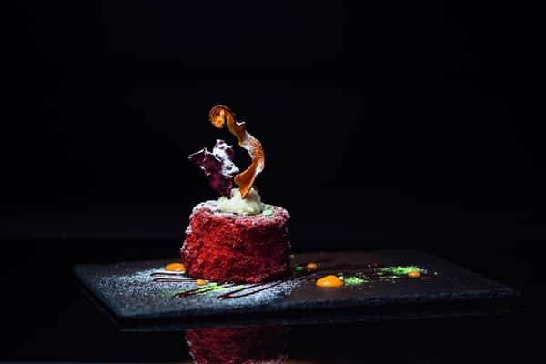 Red Velvet: Magestic, moist red velvet cake served with an assortment of dehydrated fruits and sweet sauces