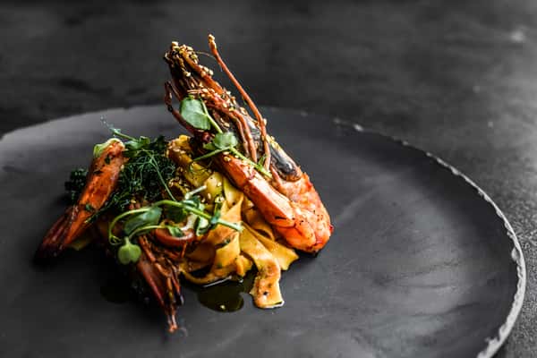 Lobster & Pasta: Grilled lobster with linguini and grilled broccoli, tossed in light soy sauce and fresh herbs.