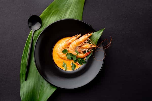 Prawn Curry: Whole prawns immersed in a yellow curry.