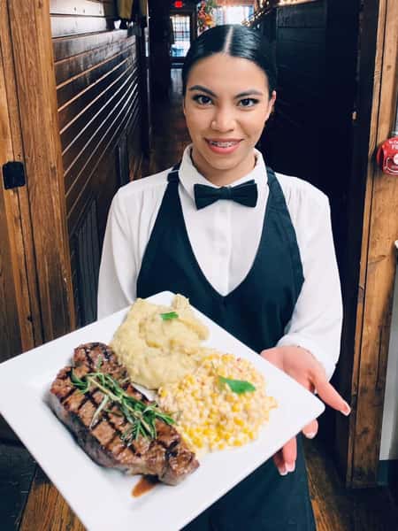 woman server holding steak