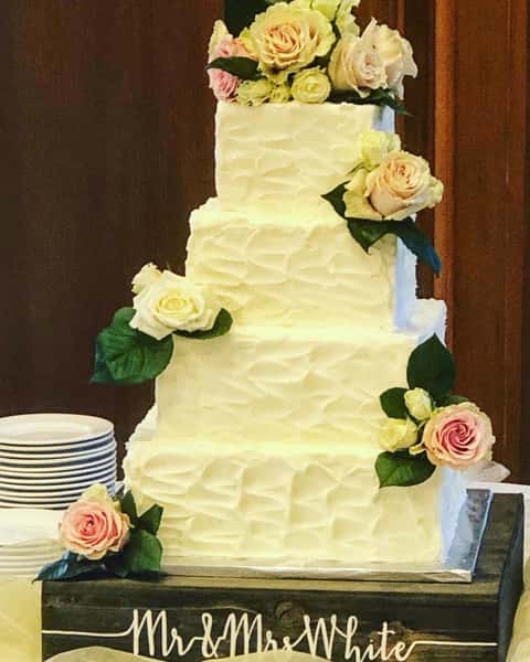 square wedding cake with fresh flowers