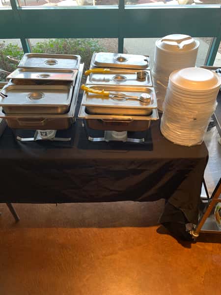 Catered pans and plates on table