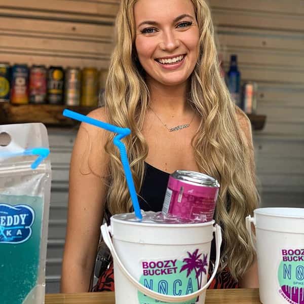 Woman smiling with booze buckets